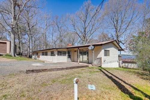 a small white house with a porch in a yard at Waterfront Louisiana Home with Private Boat Launch! in Alliance