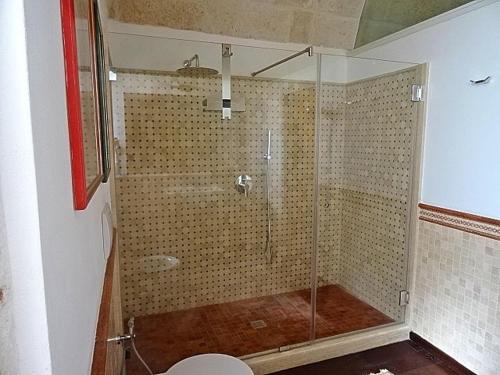 a shower with a glass door in a bathroom at Masseria Demma in Polignano a Mare