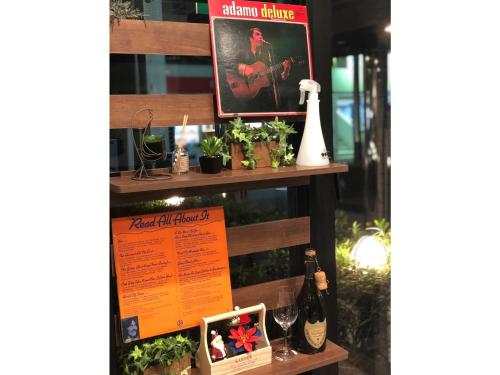 a shelf with some plants and bottles of wine at Hotel Tetora Makuhari Inagekaigan - Vacation STAY 91516v in Chiba