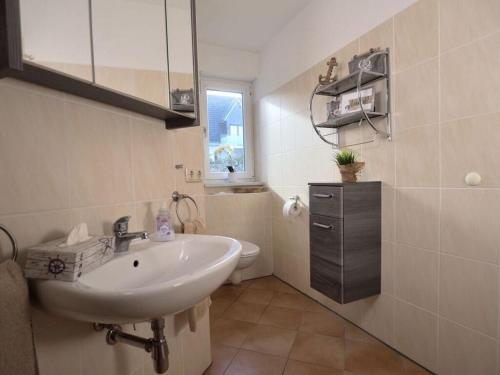 a bathroom with a sink and a toilet at Apartment Captain's Terrace in Unter Göhren