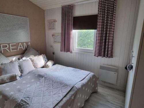 a bedroom with a bed and a window at Holiday home Amelie Comfortable Vacation Home in Sieseby