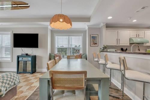 a kitchen and living room with a table and chairs at Beach Front Condo w/Pool, Restaurant, and Bar in Tybee Island