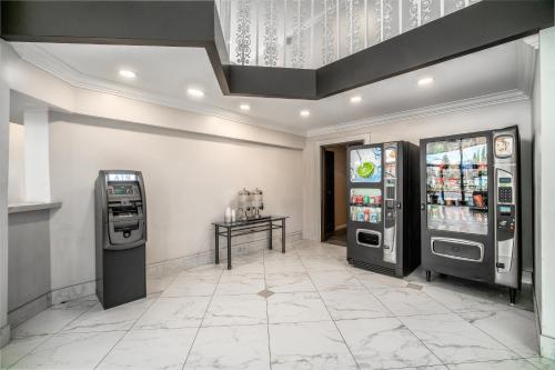 an arcade with two soda machines and a table at The Buena Park Hotel & Suites in Buena Park
