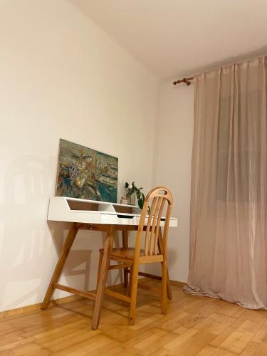 a desk with a chair and a painting on the wall at Minimal in Graz