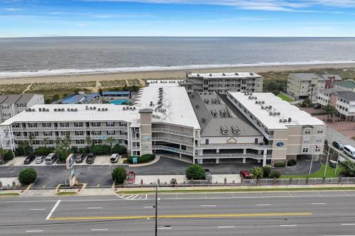 an aerial view of a hotel and the ocean at Beach Front Condo w/Pool, Restaurant, and Bar in Tybee Island