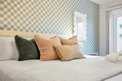 a bed with many pillows on it in a bedroom at Beach Front Condo w/Pool, Restaurant, and Bar in Tybee Island