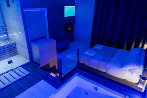 a bedroom with a tub and a bed in a room at AETERNA SUITES SPA Apartment in Terracina