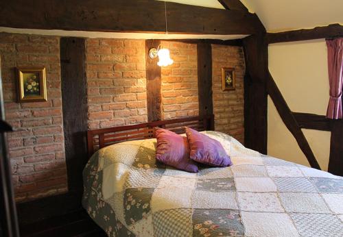 a bedroom with a bed with two pillows on it at Cider Press in Hereford