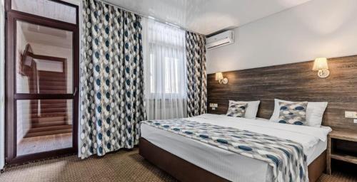 a bedroom with a large bed in a room with a window at SPA Hotel Galera in Kyiv