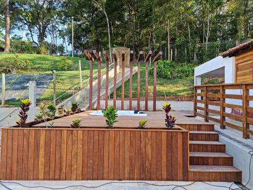 a deck with stairs and a wooden fence at Pousada Vale Do Comandante in Macacos