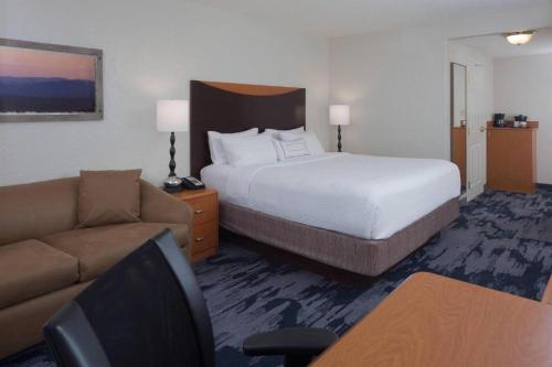 a hotel room with a bed and a couch at Fairfield Inn & Suites by Marriott Orlando Lake Buena Vista in Orlando