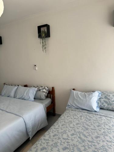 two beds sitting next to each other in a room at Torre suit property in Torre da Marinha