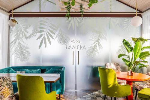 a dining room with a table and green chairs at SPA Hotel Galera in Kyiv