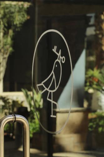 a drawing of a bird on a glass door at voco Saltillo Suites by IHG in Saltillo