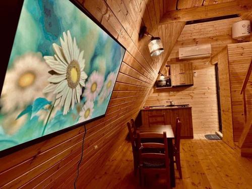 a kitchen with a large painting of a flower on the wall at Sea Light in Batumi