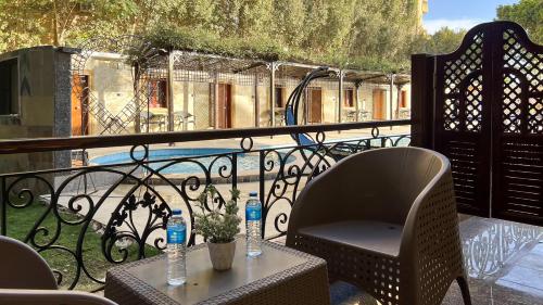 a balcony with a table and chairs on a balcony at Turquoise Pyramids Palace in Giza