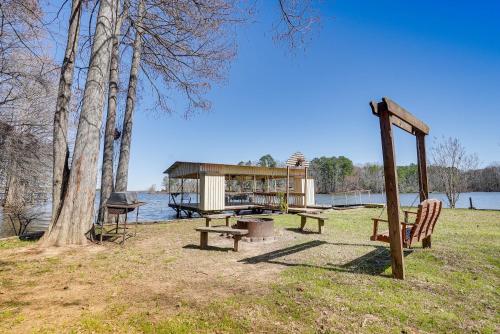 a park with a picnic table and a pavilion next to the water at Waterfront Louisiana Home with Private Boat Launch! in Alliance