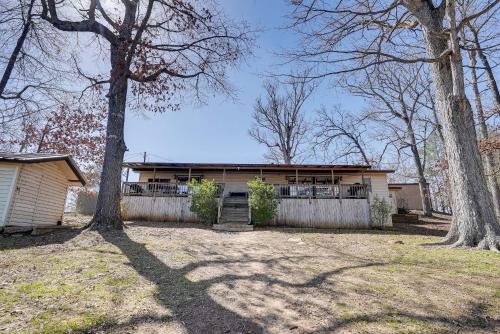 a house with a fence in front of a yard at Waterfront Louisiana Home with Private Boat Launch! in Alliance