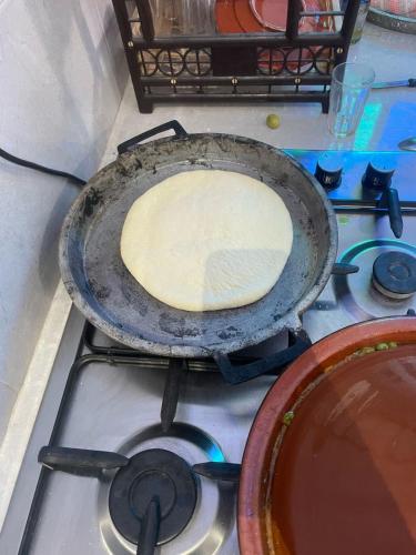 a pan on top of a stove with a pie at kasbah souss cooking in Agadir