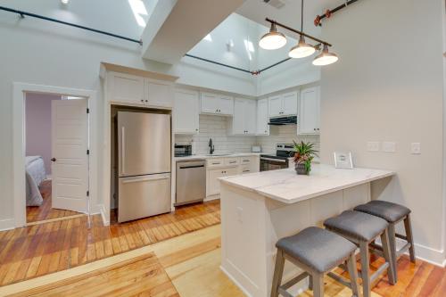 a kitchen with white cabinets and a island with stools at Spacious Downtown Hot Springs Vacation Rental! in Hot Springs