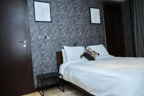 um quarto com uma cama e uma parede em Apartment 8 em Acra