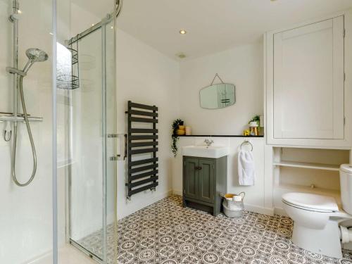 a bathroom with a toilet and a glass shower at 3 Bed in Brixham 64703 in Brixham