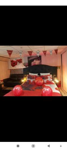 a bedroom with a large bed with red lamps on it at Péniche Morgane 2 chambre d'hôtes in Cambrai