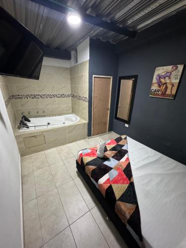 a bathroom with a bed and a bath tub at HOTEL SELECT in Medellín