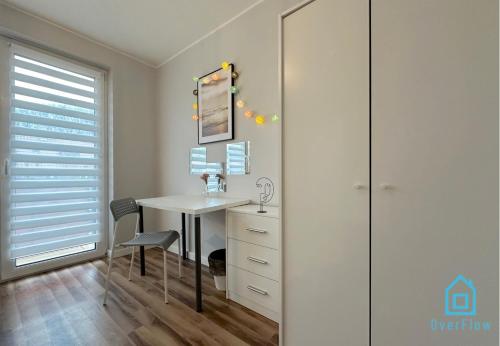 a bathroom with a desk and a glass closet at Vintage room in Gdańsk