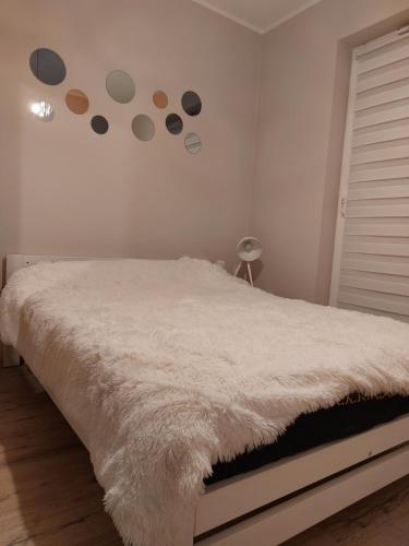 a bedroom with a bed with planets on the wall at Grey Tuwima in Olsztyn
