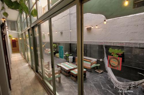 a reflection of a store window with a bench in it at Play Hostel Arcos in Buenos Aires