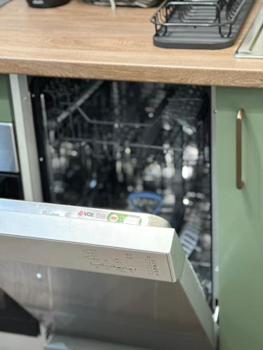 a close up of a dishwasher in a cabinet at The NADA APARTMENT of hope in Subotica