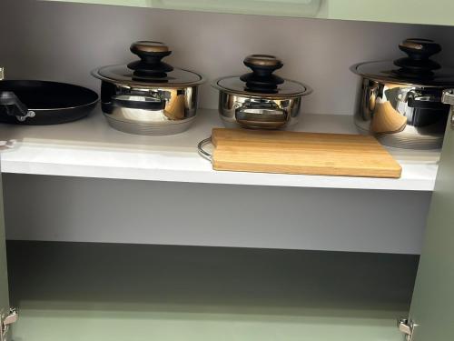 a kitchen with pots and pans and a cutting board at The NADA APARTMENT of hope in Subotica