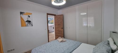 a bedroom with a bed with a pair of shoes on it at Wonderful seaview apartment - Los Cristianos in Arona