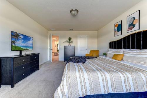 a bedroom with a large bed and a television at Luxury Living at its Finest in Davenport, FL in Davenport