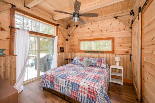 a bedroom with a bed and a ceiling fan at Lake Winnipesaukee - Waterfront - 312 in Meredith