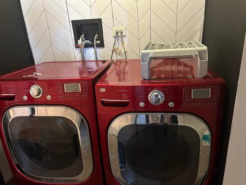 two red microwaves stacked on top of each other at Beautiful loft style townhouse-vaulted ceilings in Romeoville