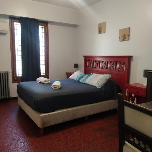 a bedroom with a bed with two towels on it at Play Hostel Arcos in Buenos Aires