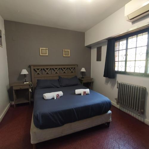 a bedroom with a bed with two pillows on it at Play Hostel Arcos in Buenos Aires