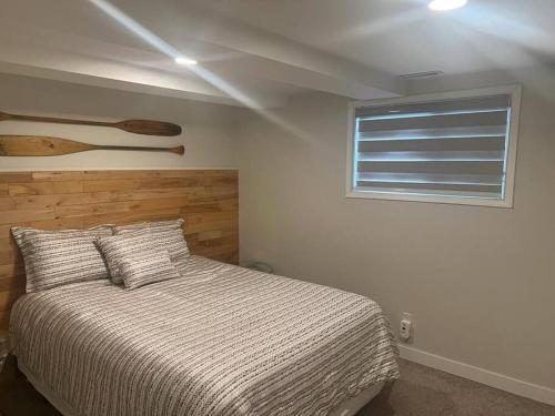 a bedroom with a bed and a window at Small lakefront cabin in Sylvan Lake