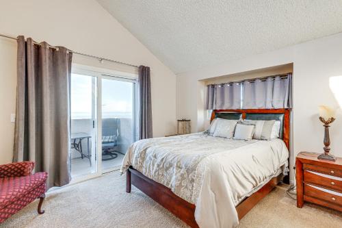 a bedroom with a bed and a window with a balcony at Pismo Beach Condo with Balcony Near Wineries! in Pismo Beach