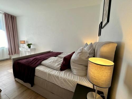 a bedroom with a bed and a table with a lamp at Retreat am Teich in Altenburg