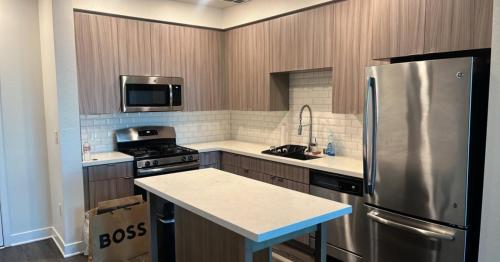 a kitchen with a stainless steel refrigerator and a sink at Glendale Charm: Stylish 1 Bedroom Retreat for Your Perfect Getaway! in Glendale