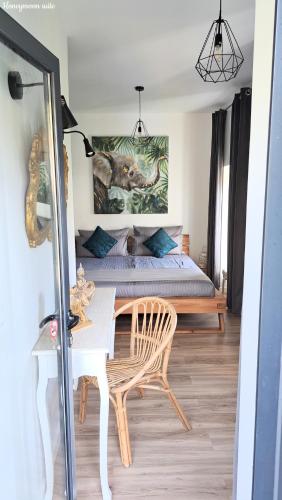 a bedroom with a bed and a table and a bed at Espirito do Mar - Premium Villa with Jacuzzi in Estreito da Calheta