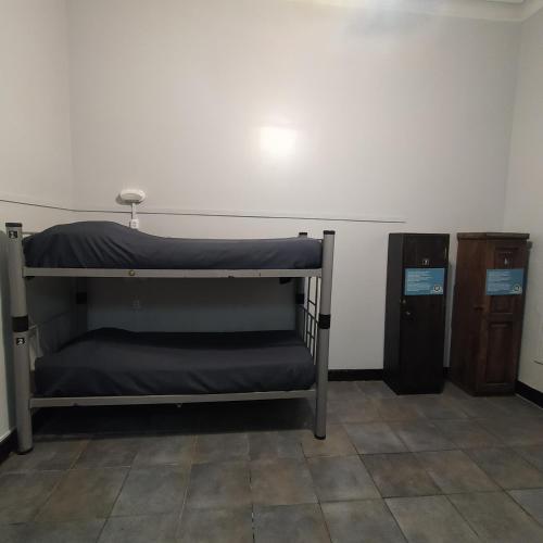 a room with two bunk beds and a cabinet at Play Hostel Arcos in Buenos Aires