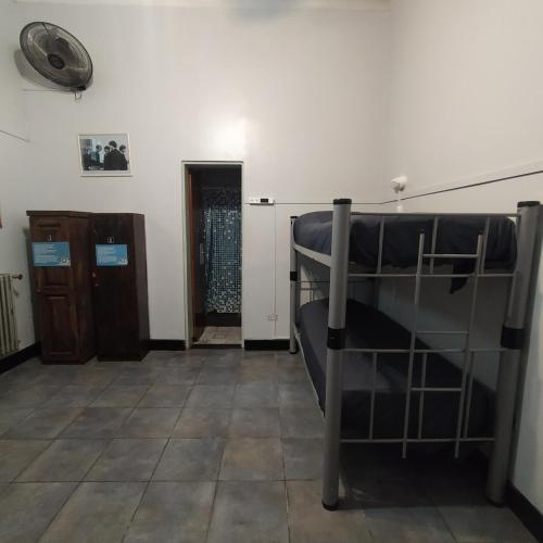 a room with two bunk beds and a door at Play Hostel Arcos in Buenos Aires