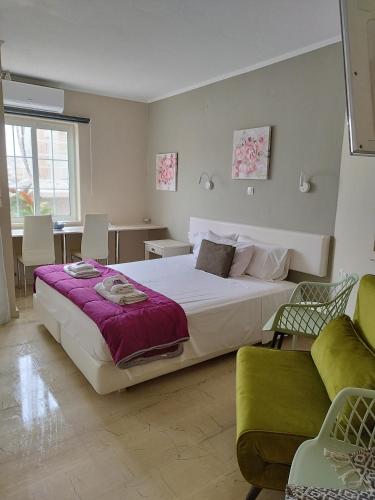 a bedroom with a large white bed and a couch at Villa Katerina in Chania