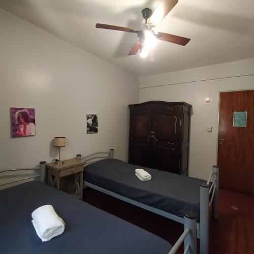 a hospital room with two beds and a ceiling fan at Play Hostel Arcos in Buenos Aires
