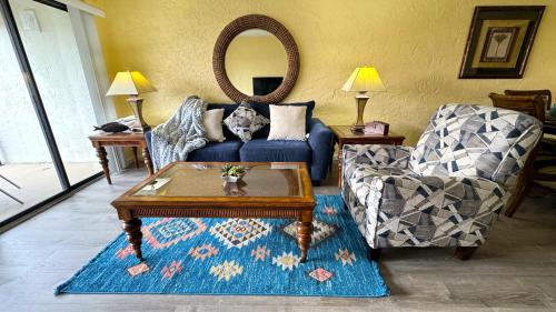 a living room with a blue couch and a table at Sugar Beach Condo in Panama City Beach