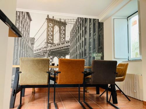 a dining room with a table and chairs with a view of the city at Casa SuasDuas in Vila Cova de Alva